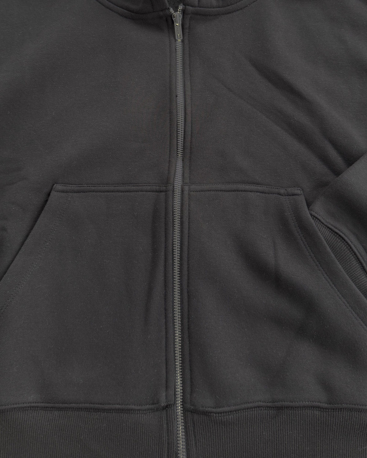Oversized Crop Zip hoodie in Black, close-up of the zip and pocket