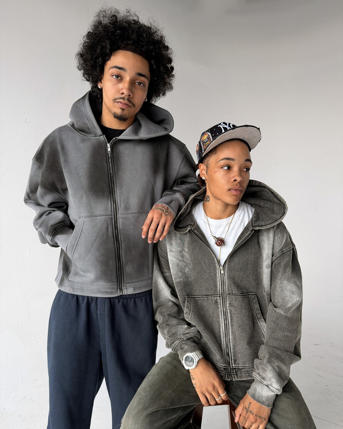 Uptown Crop cropped zip-up hoodies in Washed Grey and Acid Wash, on two models