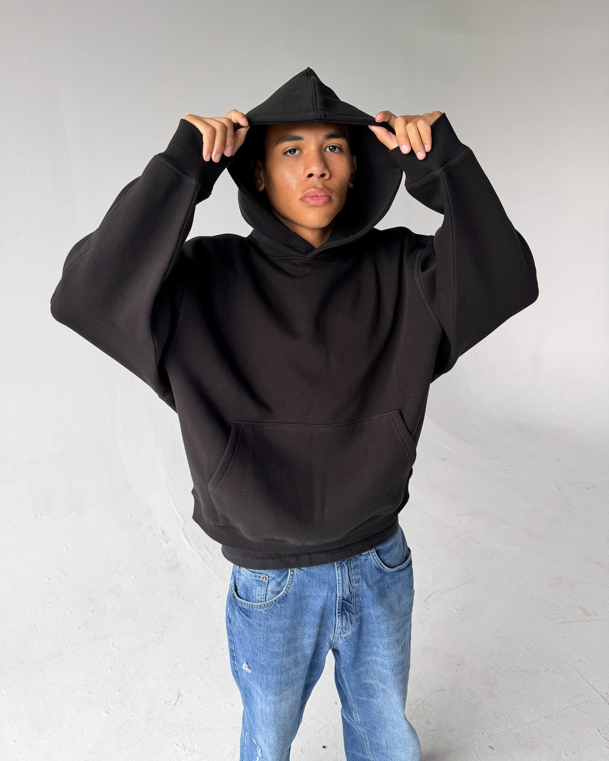 Brooklyn Classic pullover hoodie in Black, hood up, on a model