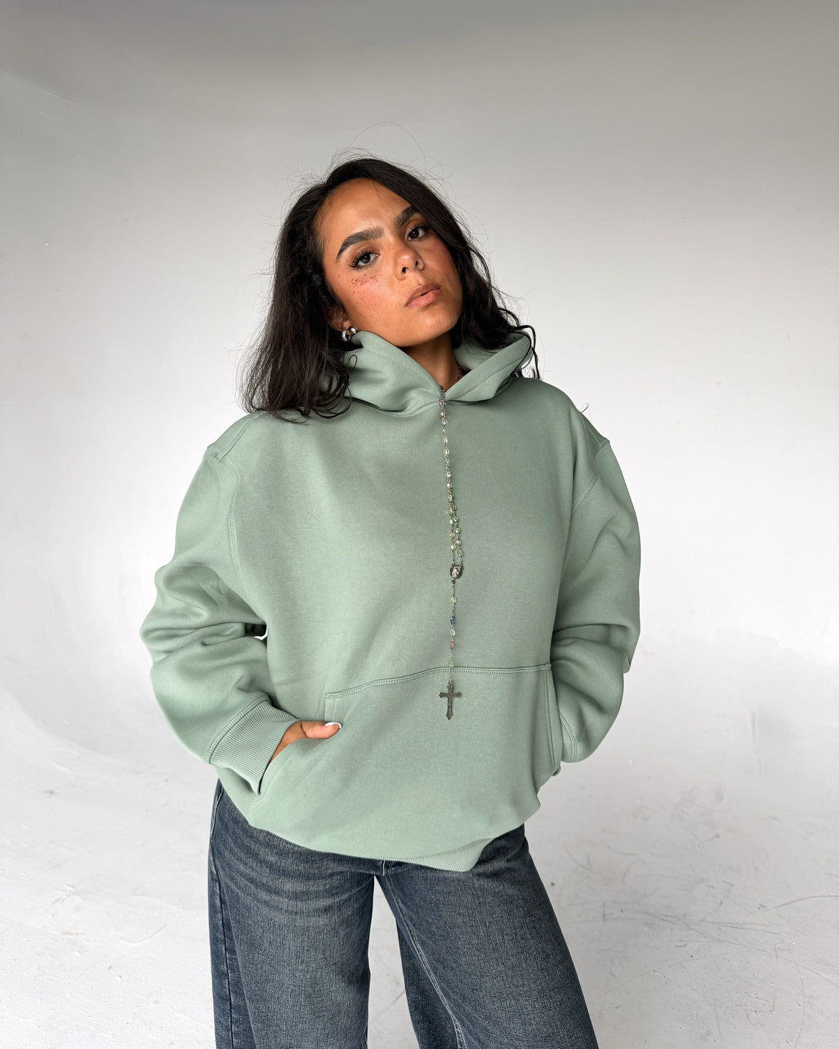 Brooklyn Classic pullover hoodie in Sage, front, on a model