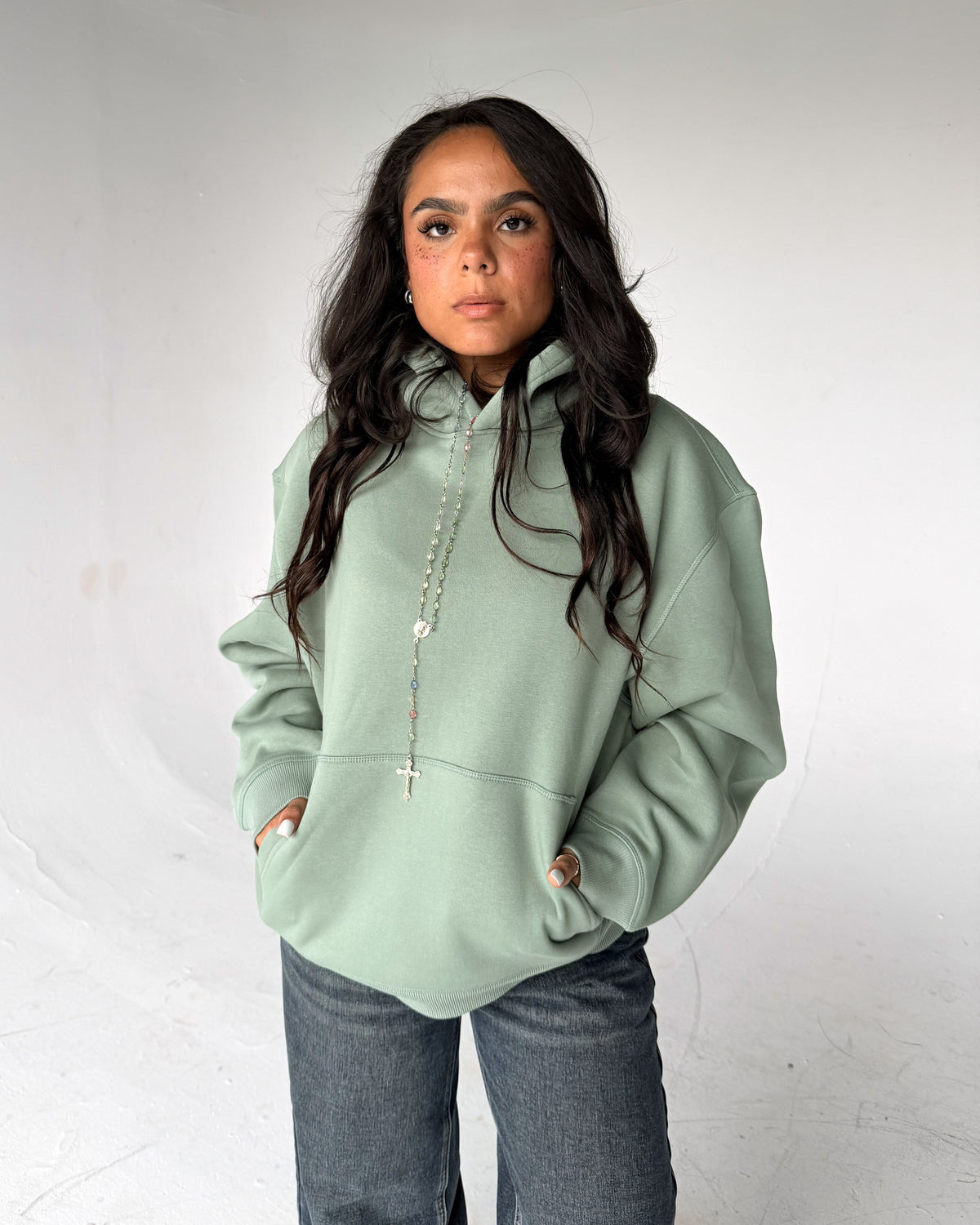 Brooklyn Classic pullover hoodie in Sage, front, on a model