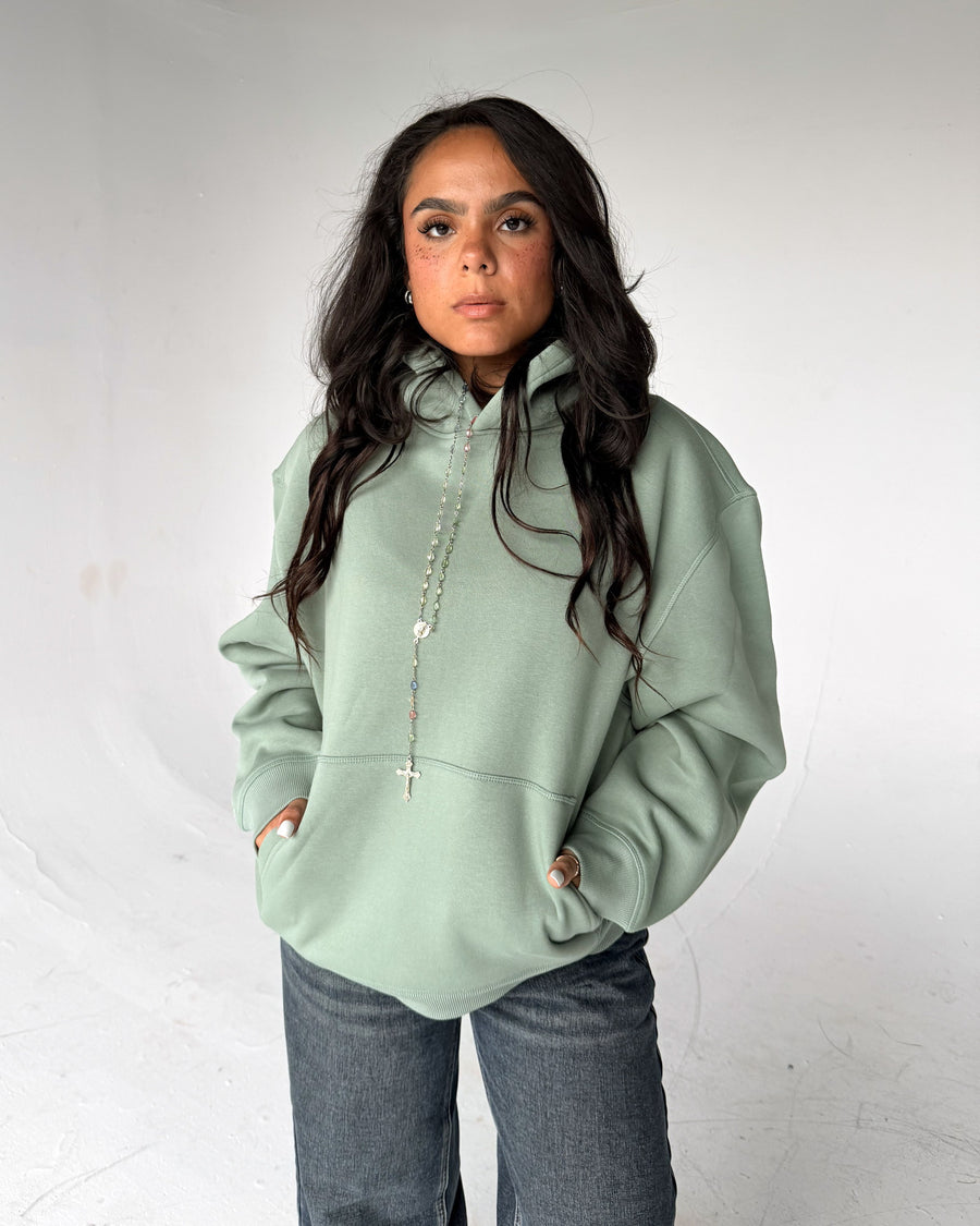 Brooklyn Classic pullover hoodie in Sage, front, on a model