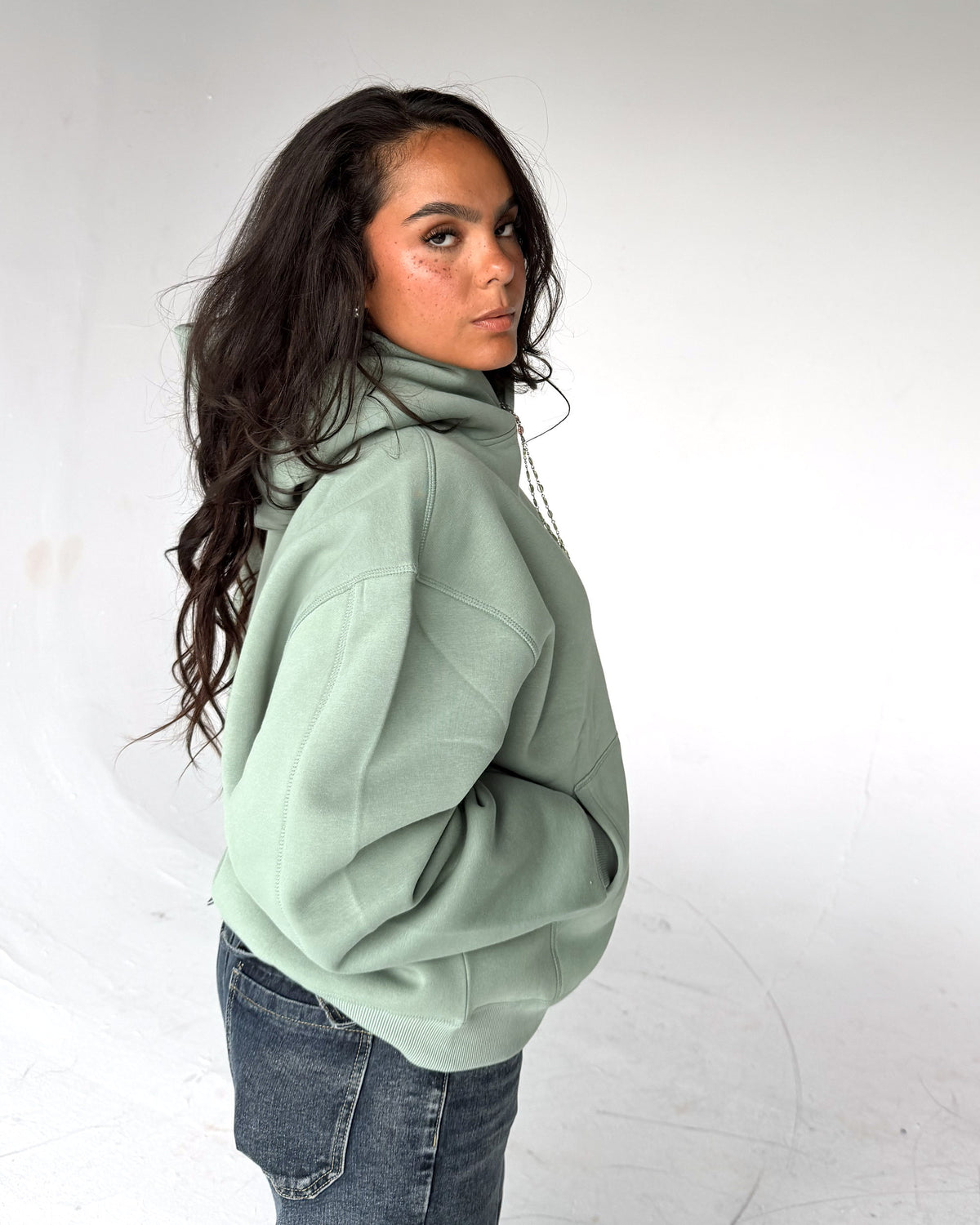 Brooklyn Classic pullover hoodie in Sage, side, on a model