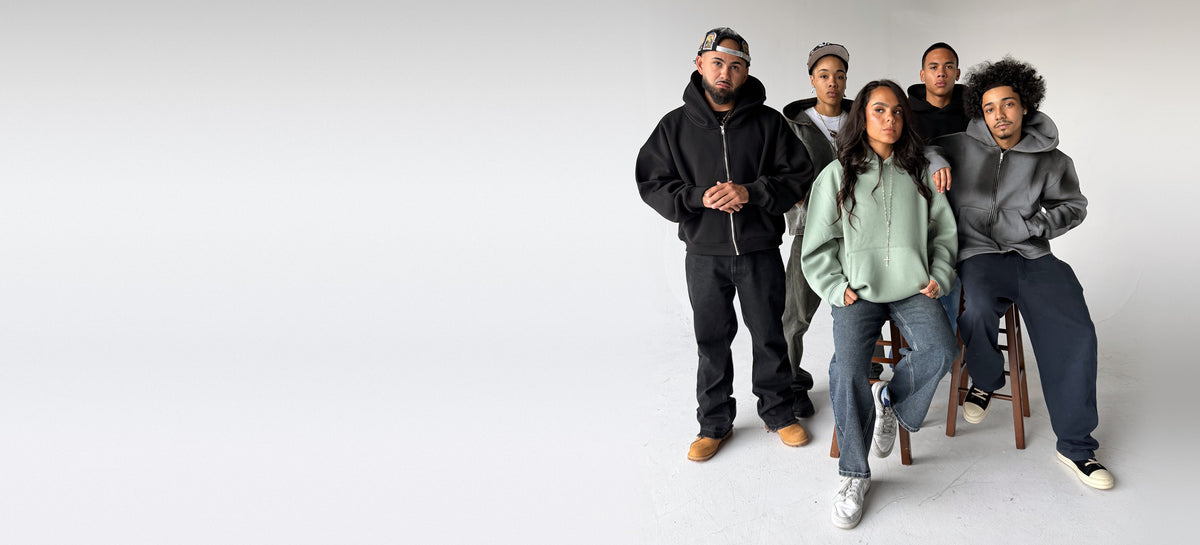 Five people wearing Brooklyn Blanks heavyweight cotton hoodies in black, sage, washed grey and acid wash