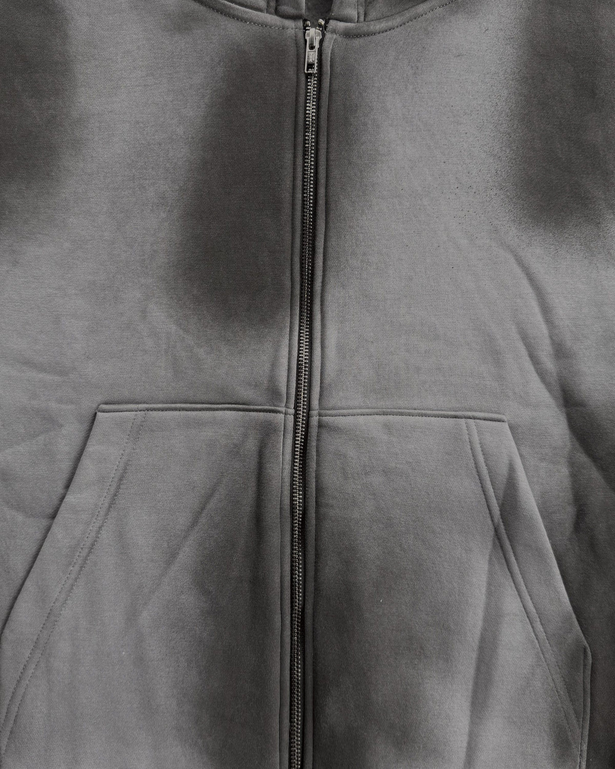 Uptown Crop cropped zip-up hoodie in Washed Grey, close-up of the zip, pocket and wash